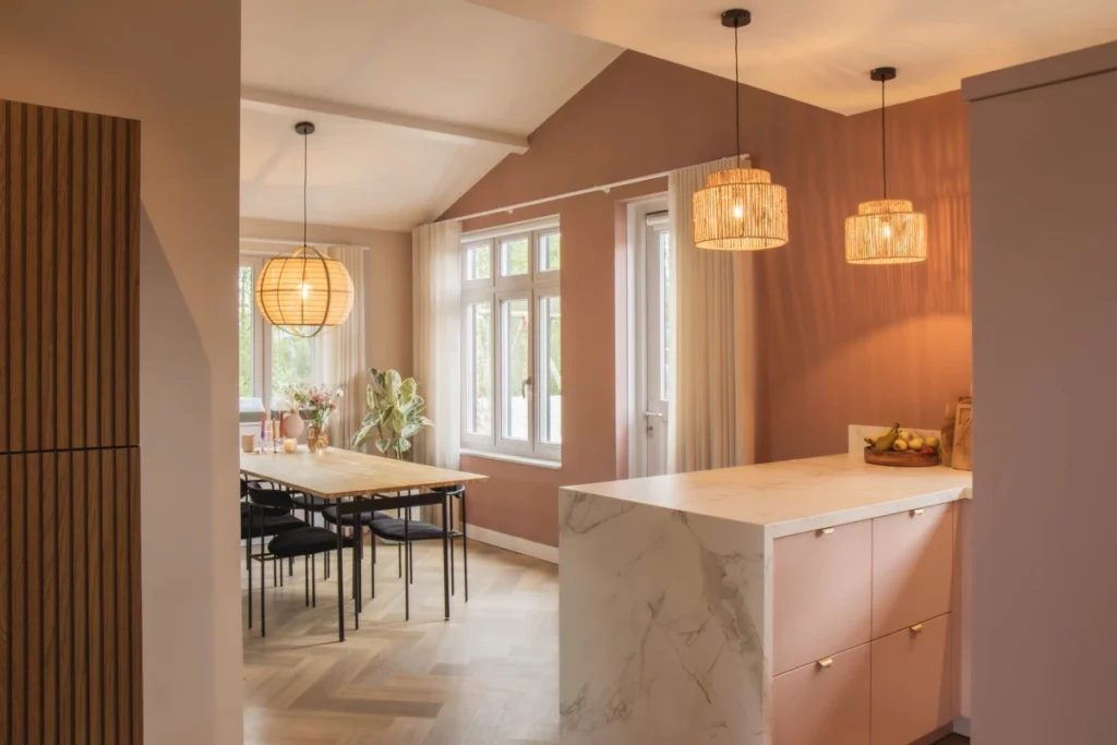 Moderne keuken van Mennen Keukens + Interieurs met schiereiland en eettafel, Mereno Milano front in roze kleur